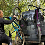 Loading two bikes onto Tokul Racks Panel Bike Rack on van rear door